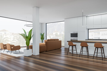 Corner view on bright studio interior with island with barstools