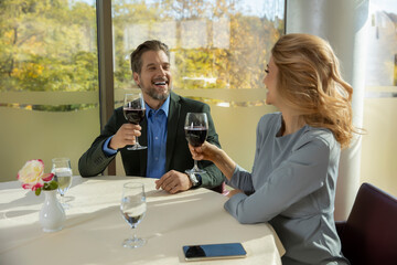 Romantic couple toasting with wine in the restaurant