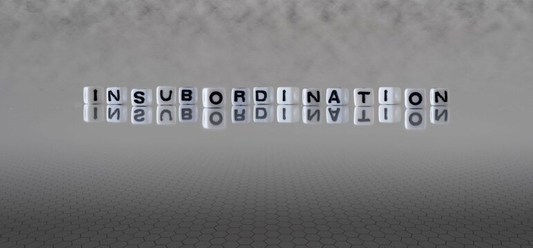 insubordination word or concept represented by black and white letter cubes on a grey horizon background stretching to infinity