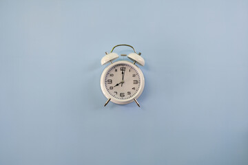 Minimalist alarm clock on a blue background