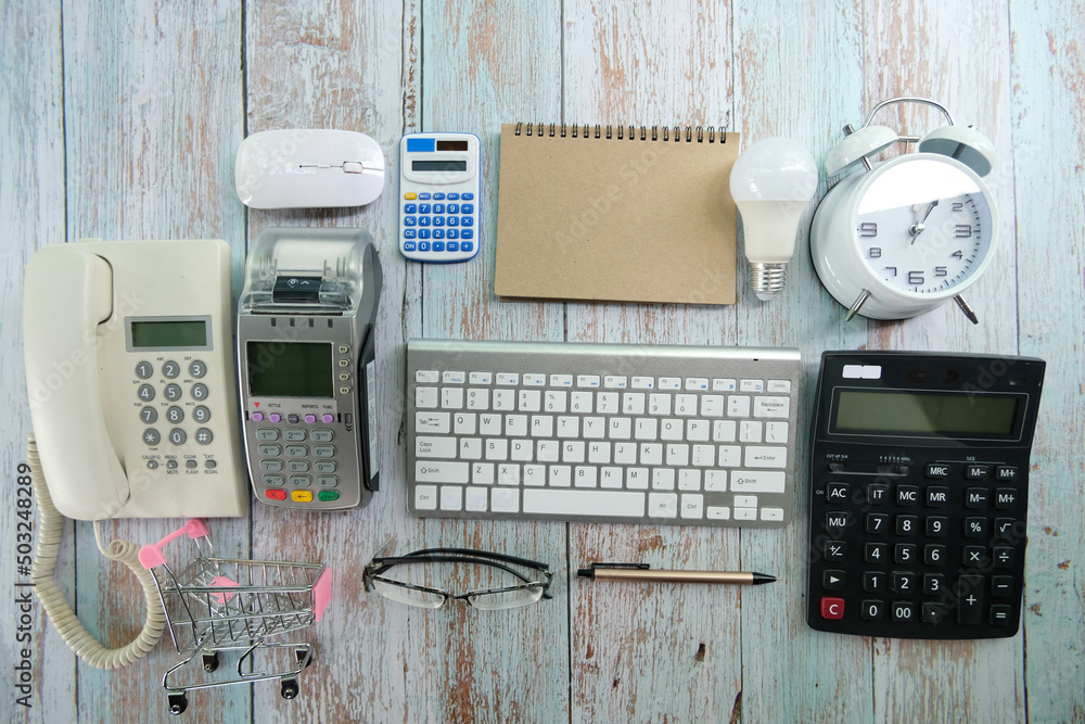 Poster office desk with computer keyboard, pen, eyeglasses, and notebook top view with copy space of a cup 