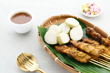 Chicken satay (sate ayam) with Lontong and peanut sauce. One of the popular street food in...