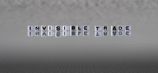 invisible trade word or concept represented by black and white letter cubes on a grey horizon background stretching to infinity