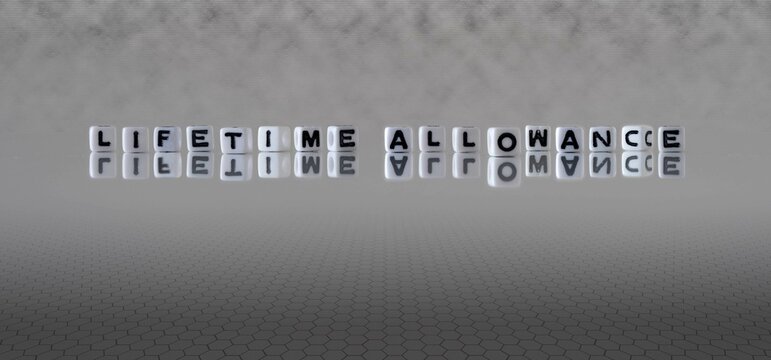 Lifetime Allowance Word Or Concept Represented By Black And White Letter Cubes On A Grey Horizon Background Stretching To Infinity