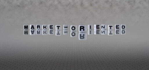 market oriented word or concept represented by black and white letter cubes on a grey horizon background stretching to infinity