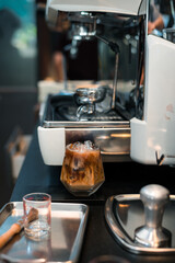 Close-up of iced coffee served on black table at cafe​