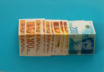 jerusalem-israel. 03-05-2021. Banknotes of Israeli money on a blue background