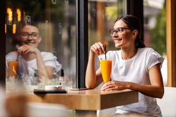A woman in a bar drinking juice.
