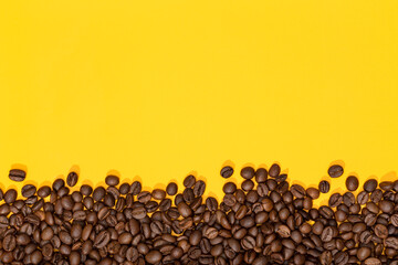 Coffee beans on yellow background