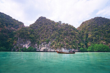 Obraz premium Vacation on island. Beautiful landscape with sea, boat and rocks.