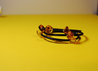 beautiful bracelet with amber on a yellow background