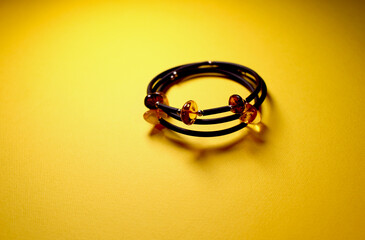 beautiful bracelet with amber on a yellow background