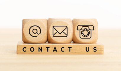 Contact us concept. Wooden blocks with email, mail and telephone icons.Website page contact us or e-mail marketing