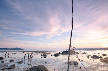 Beautiful sunset landscape with sea beach and fishing net.