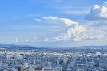City paranoma with clear houses and a big floating cloud in summer