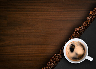 Cup of coffee with coffee beans on table
