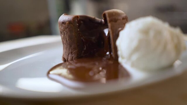Chocolate fondant or lava cake on white plate.