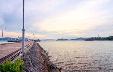 Obraz premium Landscape with concrete pier on the sea shore.