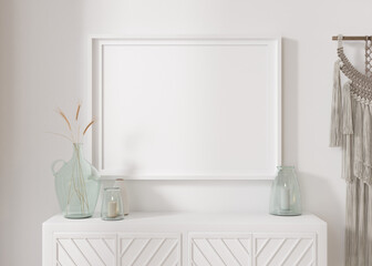 Empty horizontal picture frame on white wall in modern living room. Mock up interior in minimalist, contemporary style. Free space for your picture. Console, dried grass in vase, macrame. 3D rendering