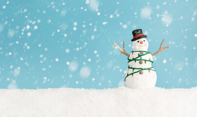 Happy snowman standing in winter christmas landscape