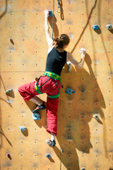 girl climbing up the wall