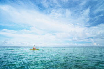 Active water sport and leisure, kayaking. Man Paddling Canoe Kayak In Tropical Ocean, Enjoying Recreational Sporting Activity.