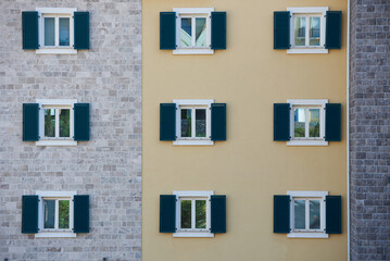 Fototapeta na wymiar Windows with shutters on an apartment building