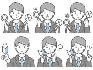 〇✕マークや初心者マークを持つスーツの中年男性