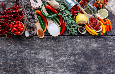 different seasonings for cooking,  varieties of hot chilli pepper, ground pepper and spices, oil. for the text recipe