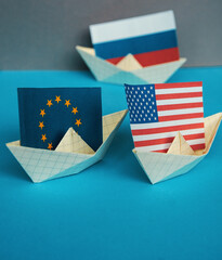 paper ship with national flag of Russia, united states of america and Europe union concept of...