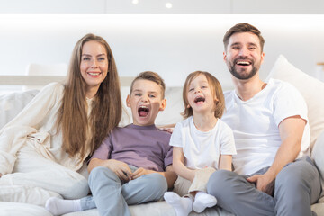 Happy family with children on sofa