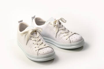 Pair of Stylis New White Sneakers Over White Background. Horizontal Image
