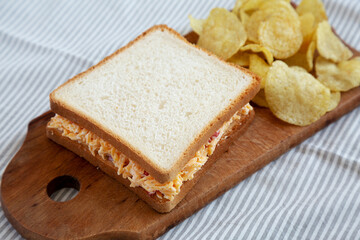 Fototapeta na wymiar Homemade Pimento Cheese Sandwich with Chips, side view.