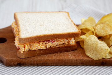 Fototapeta na wymiar Homemade Pimento Cheese Sandwich with Chips, low angle view. Close-up.