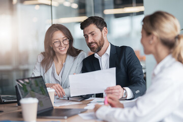 businessmen discussing documents with graphs and charts in a modern office during meeting. 