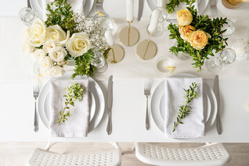 The wedding table setting, top view. Wedding teble decoration with white roses and boxwood