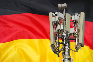 5G network antenna base station on background German flag. 6G network antenna base station on...