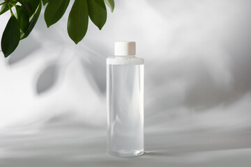 mockup of clean bottle of micellar water on gray background - obrazy, fototapety, plakaty