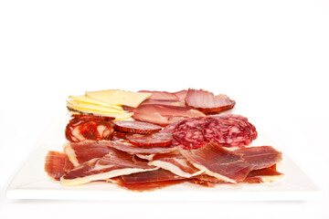 Ration with Spanish ham, sausage, loin and cheese on white background.