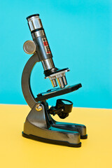 School microscope with a blue and yellow bottom
