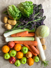 Healthy eating: grocery shopping or delivery of fresh fruits and vegetables. Rich vitamin vegetables. Variety of fruits and vegetables on craft paper. Fresh potatoes lettuce purple sprout broccoli lee