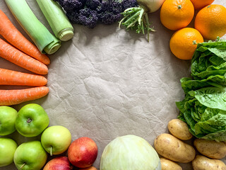 Healthy eating: grocery shopping or delivery of fresh fruits and vegetables. Rich vitamin vegetables. Copy space Variety of fruits and vegetables on craft paper. Fresh potatoes lettuce purple sprout b