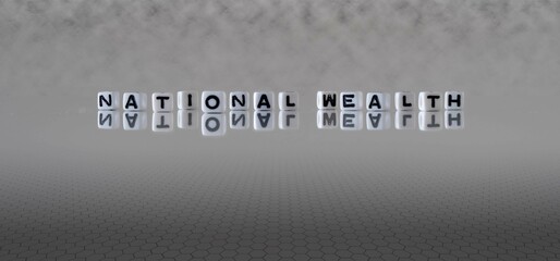 national wealth word or concept represented by black and white letter cubes on a grey horizon background stretching to infinity
