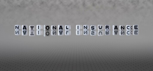 national insurance word or concept represented by black and white letter cubes on a grey horizon...