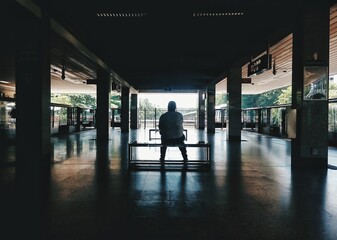 Lone person sitting by the train station
