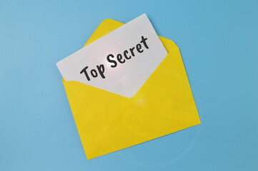 Yellow envelope and white paper written with TOP SECRET