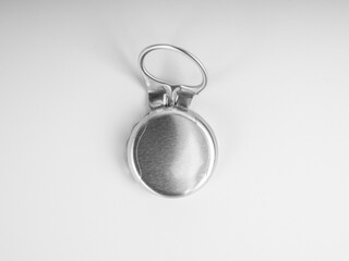 Close-up used silver ring pull bottle cap of glass bottle with blank space on the cap isolated on white background, top view.