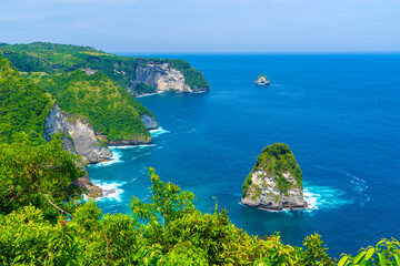 Paluang cliff above beautiful blue waters near Kelingking Beach on Nusa Penida island.