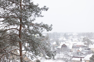 Aerial view to the private houses in snowing weather.