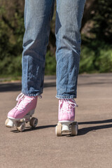 woman skating in jeans and pink roller skates
